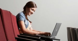 Student typing on laptop