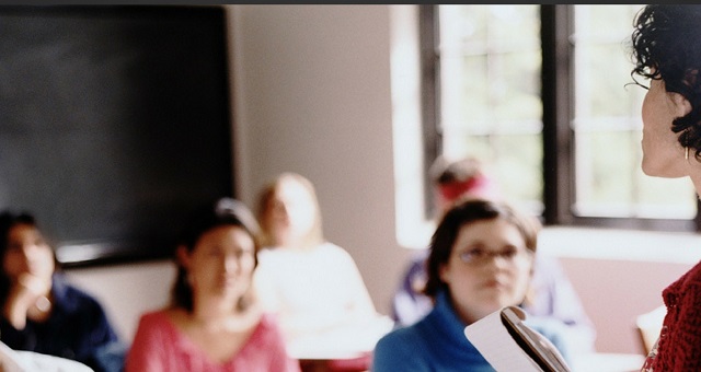 female professor in front of small class