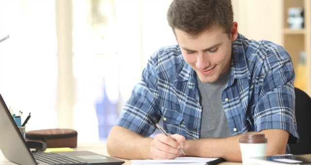 Student writing notes