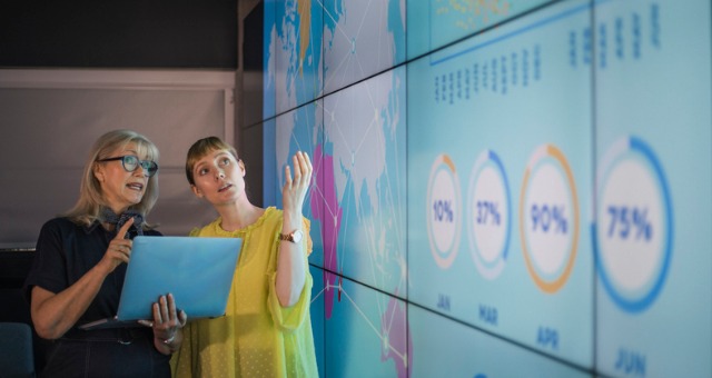 Teacher and student look at projected content that's engaging