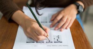 Student takes test assessment in class