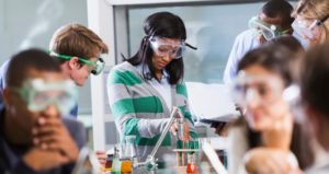 College students experiment with test tubes in the science lab