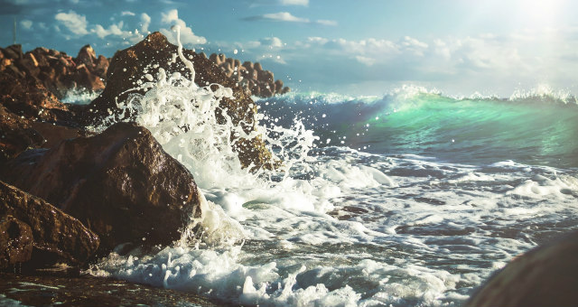 Tide crashes against rock in metaphor representing online students who are struggling
