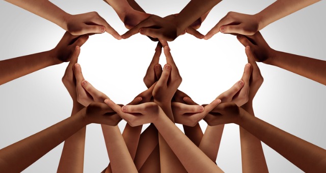 Hands emerge together to form hearts, symbolizing fairness and equality in the classroom