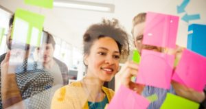 Students gather for starter activity by placing sticky notes in front of class