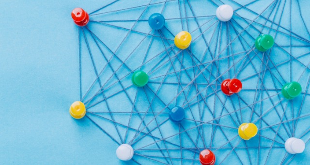 Pin tacks with string represent communication coming from all directions in the classroom