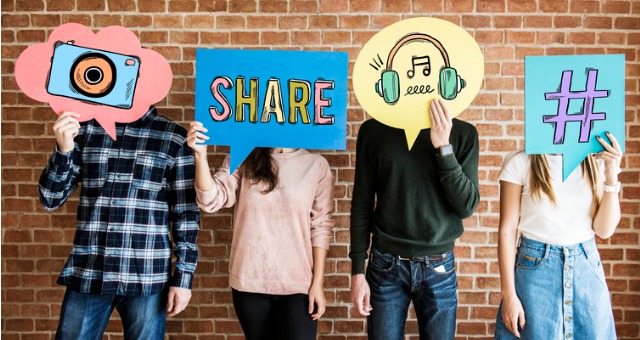 People hold up different icons such as a camera, the word "share", a hashtag, and headphones