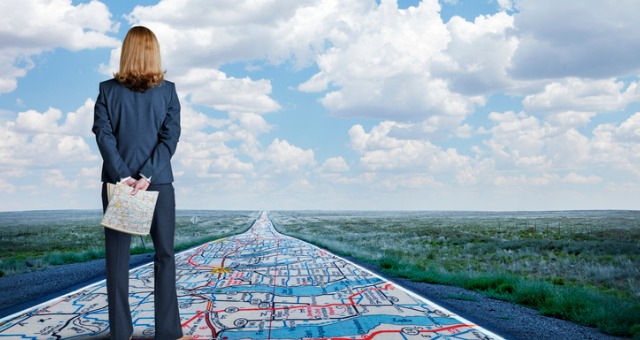 Woman stands on roadmap overlooking road