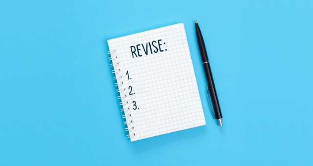 Notepad with the word "revise" written on it with numbers 1 through 3