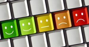 Computer keys have faces ranging from green smileys to red frown
