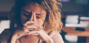 Student puts hands on head feeling sad and lost