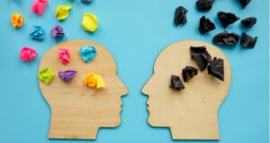 Two heads with colorful and dark thoughts