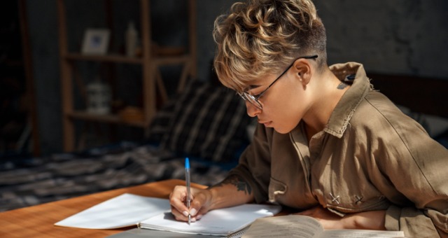 Student writes at desk