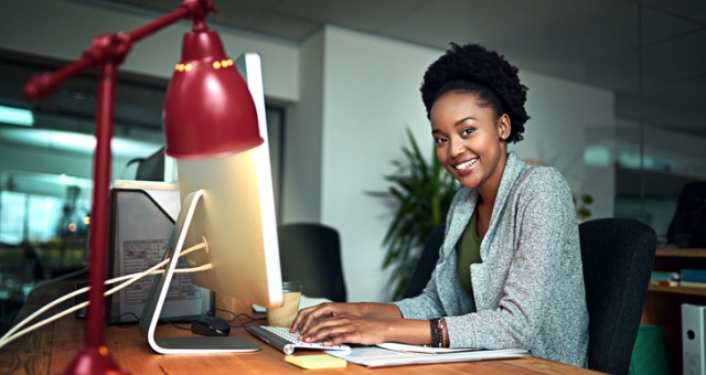 Woman smiling while at computer desk