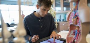 Student is in science lab working on assignment