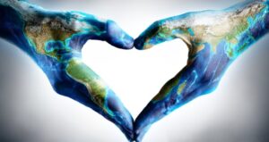 Hands are painted as the Earth with hands in heart shape