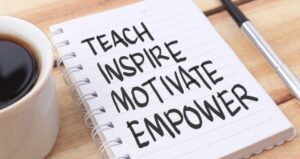 Teach, inspire, motivate, and empower written on notepad