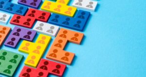 Puzzle pieces in different colors with people icon lay as a puzzle