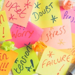 Sticky notes with words like stress, anxiety, and doubt written on it