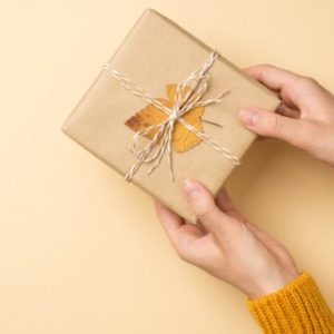 Person holds gift with leaf on it