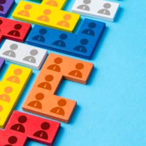 Puzzle pieces in different colors with people icon lay as a puzzle
